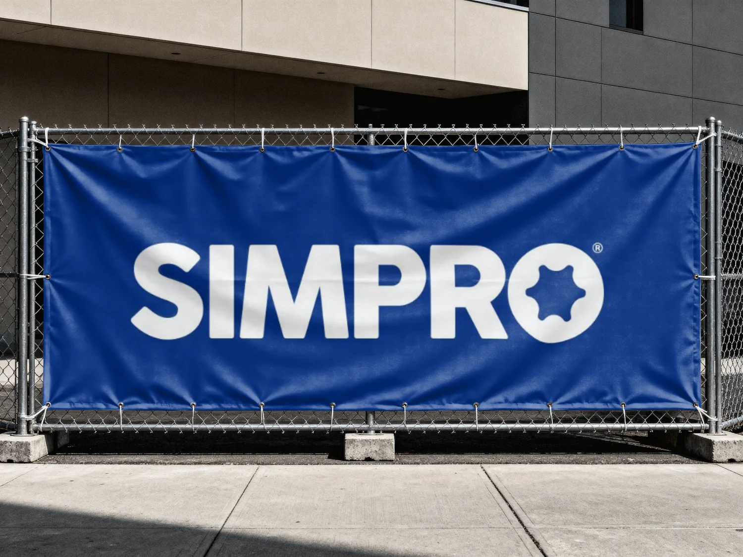 SIMPRO banner on a construction site fence